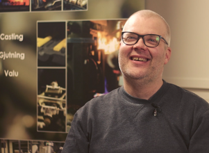 Man in an office, laughing