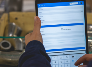 A person holding a tablet computer in their hands.