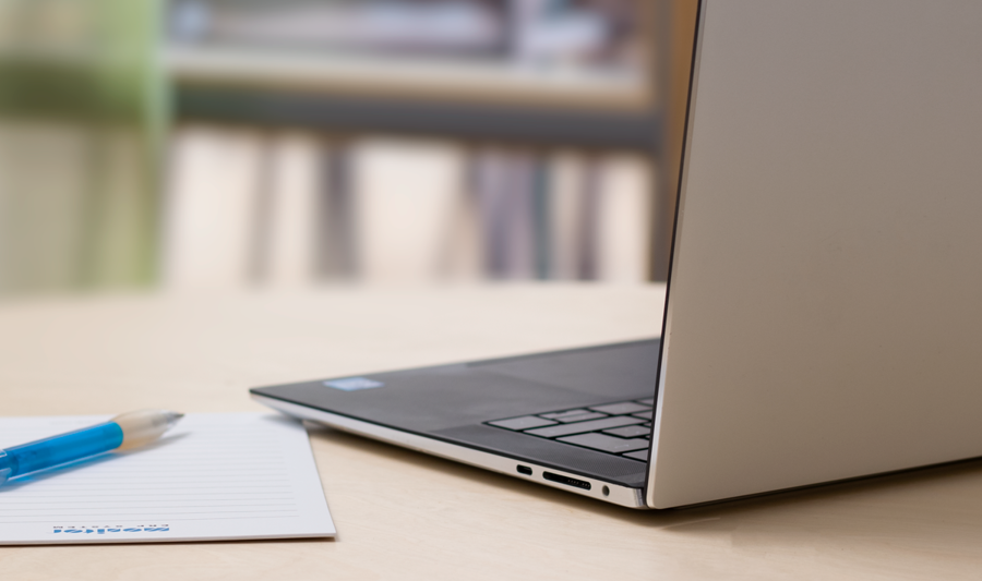 A laptop computer sitting on top of a wooden table.