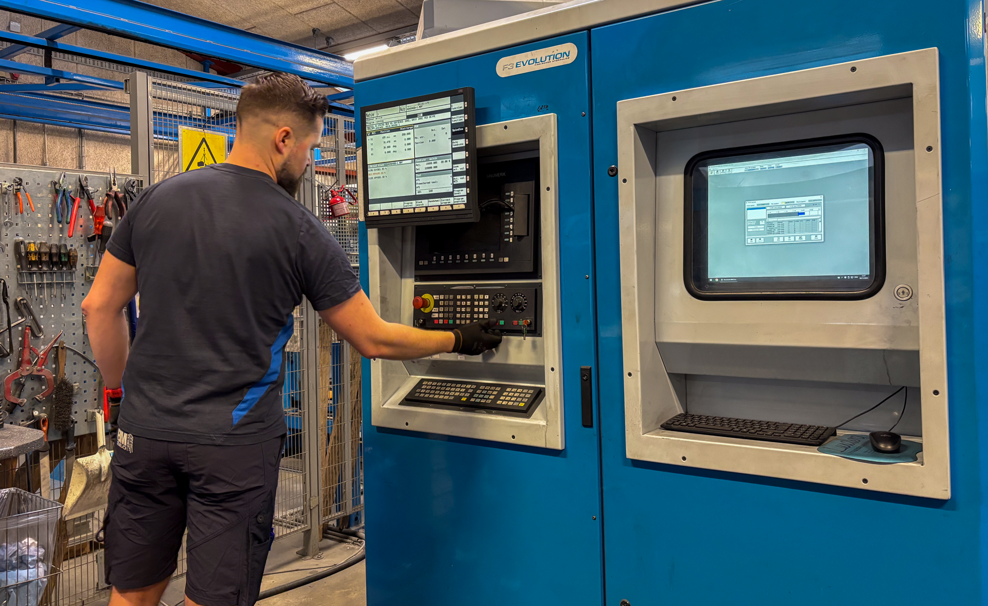 Production Manager Mikkel working on a machine.