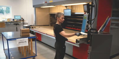 A woman working on a machine in a factory.