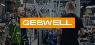 A group of men standing next to each other in a factory.