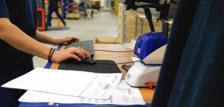 A man working on a computer in a factory.