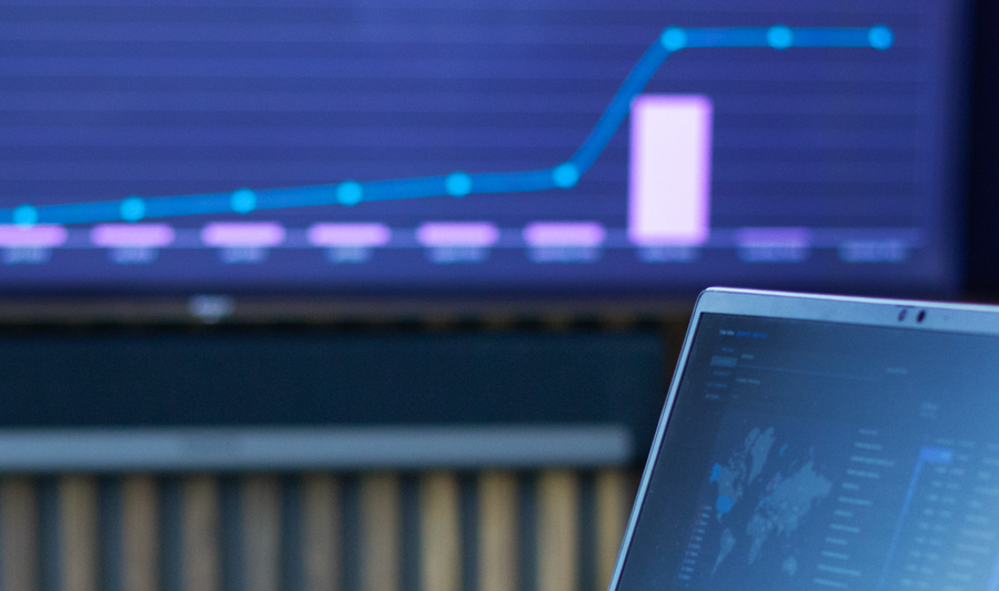 laptop on a table showing Monitor ERP Dashboard
