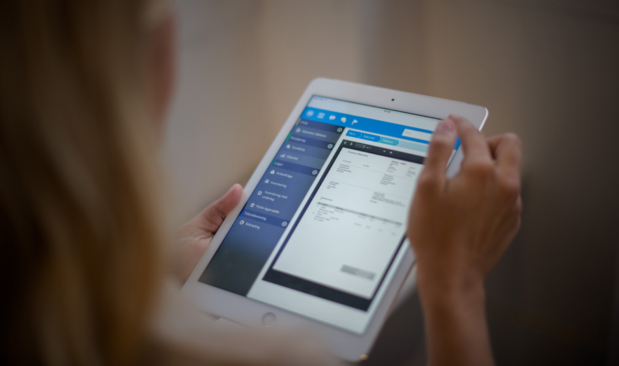 A white tablet showing Monitor ERP.