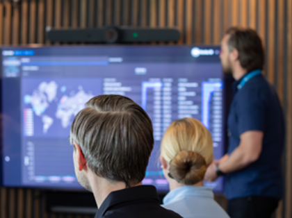 A man at Monitor giving a presentation to a group of people about Monitor BI (business intelligence)