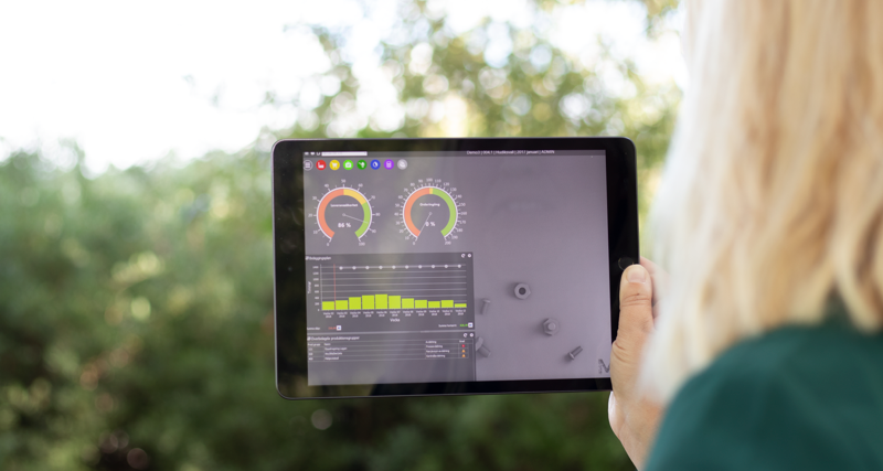 Illustration of Monitor ERP dashboards on a screen placed in nature, symbolizing sustainability.