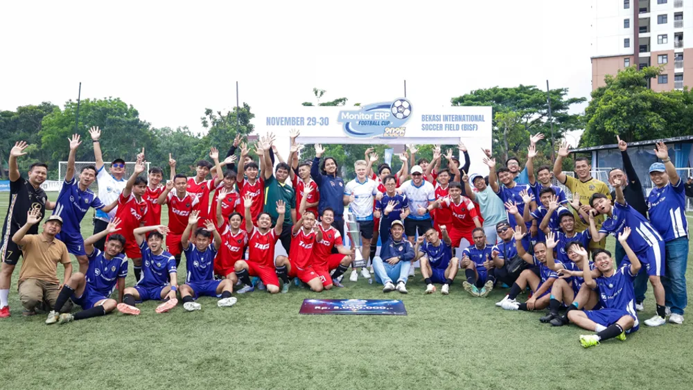 A group of people, appearing to be a football team, is celebrating their victory at an event, Monitor ERP Football Cup 2025