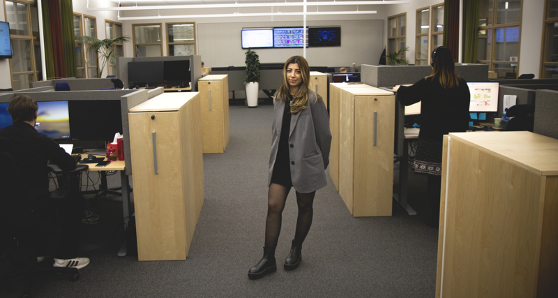 Hazal står i ett kontorslandskap.