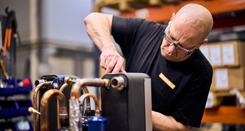 A man working on a machine in a factory.