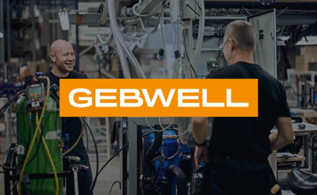 A group of men standing next to each other in a factory.