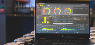 Monitor ERP dashboard displayed on a laptop in a factory environment