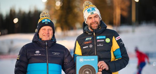 Two men standing next to each other holding a plaque.