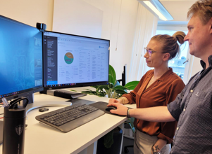 Man and a woman looking at a computer