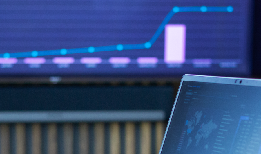 laptop on a table showing Monitor ERP Dashboard