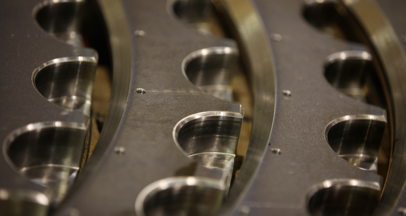 A close up of a metal object with holes in it.