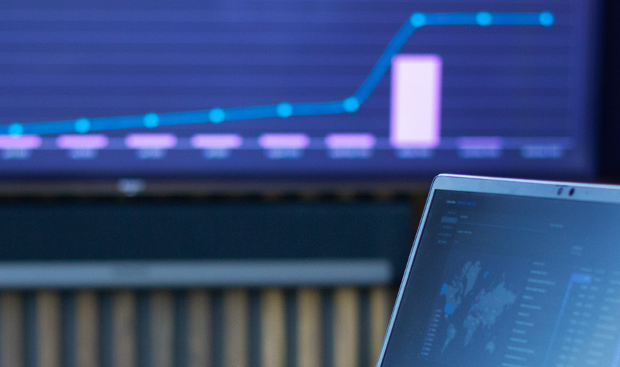 laptop on a table showing Monitor ERP Dashboard