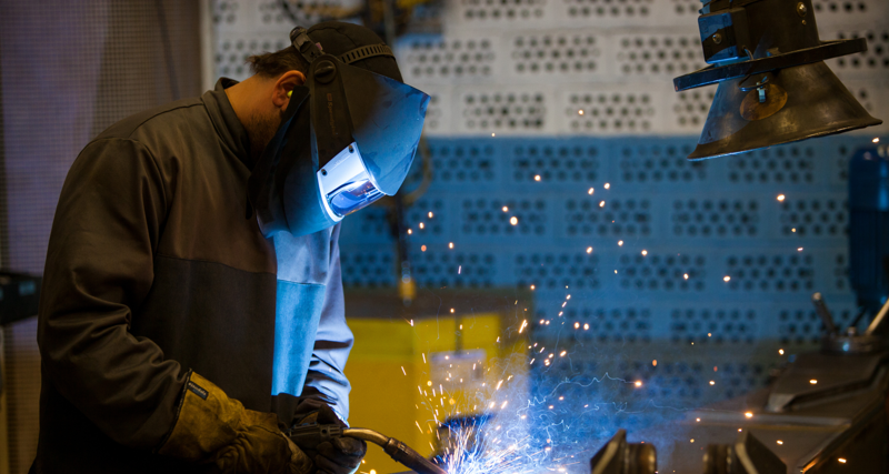 A welder working on a piece of metal.