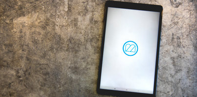 A computer tablet displaying Monitor ERP logo.