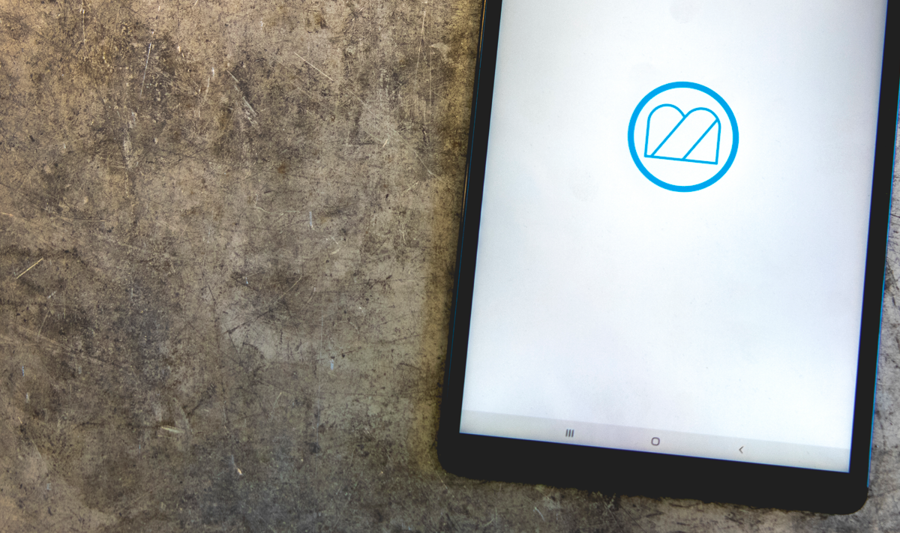 A computer tablet displaying Monitor ERP logo.