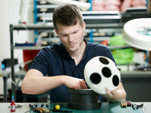 Man in factory working with tool.