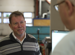 Two men talking in a factory
