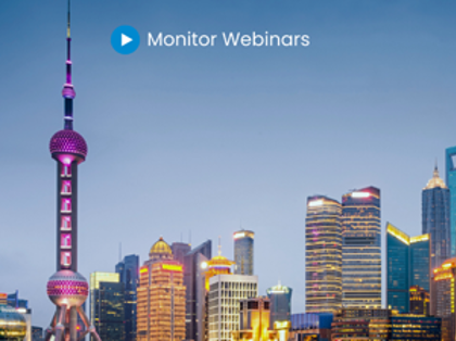 A picture of a city at night with the words monitor webinars.