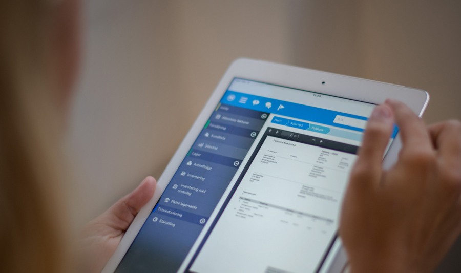 Woman holding a white tablet.