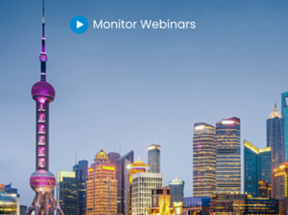A picture of a city at night with the words monitor webinars.