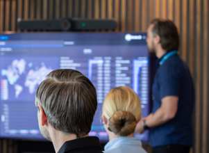 A man at Monitor ERP giving a presentation to a group of people about Monitor BI (business intelligence)