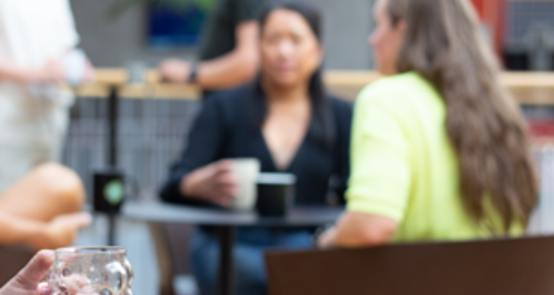 A woman sitting in front of a group of people.