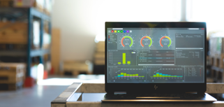 Monitor ERP dashboard displayed on a laptop in a factory environment