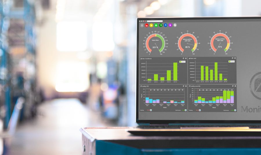 Monitor ERP dashboard displayed on a laptop in a factory environment