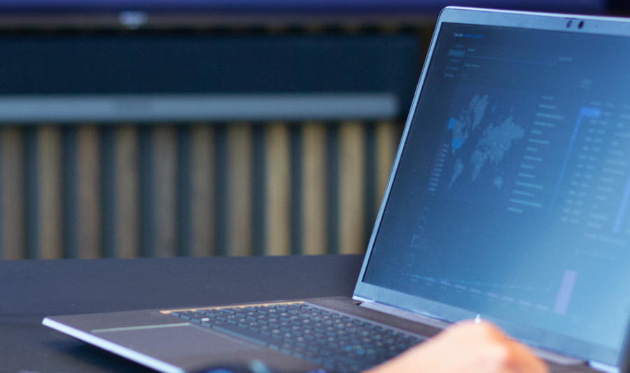laptop on a table showing Monitor ERP Dashboard