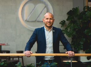 Man in a suite standing in an open-plan office