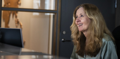 A woman sitting at a desk in an office.