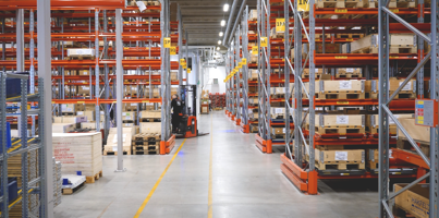 A large warehouse filled with lots of shelves.