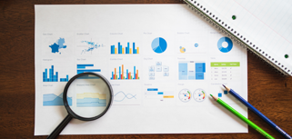 A magnifying glass sitting on top of a piece of paper.